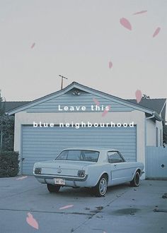 an old car is parked in front of a garage with the words leave this blue neighborhood