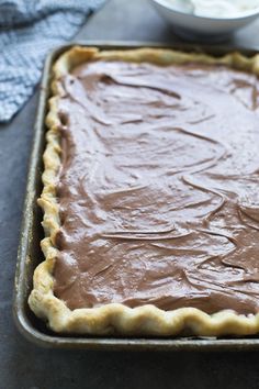 a chocolate tart crust in a baking pan