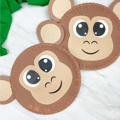 two paper plates with monkey faces on them