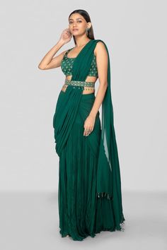 Emerald green round neck blouse with all over floral pattern and zardozi embroidery.  Paired with pre-draped skirt saree with intricate pleated details, attached draped pallu and stone drop tasselled belt. - Aza Fashions Draped Saree Gown, Bottle Green Saree, Skirt Saree, Pleated Saree, Saree Ideas, Wedding Lehenga Designs, Zardozi Embroidery, Saree Gown, Drape Saree