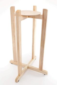 a small wooden table with two legs and a round plate on it's stand