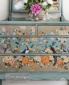 an old dresser with flowers and birds painted on it