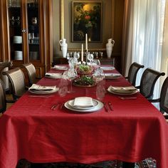 a dining room table is set with place settings