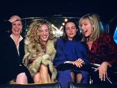 three women sitting next to each other in a car