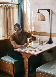 a man sitting at a table eating food