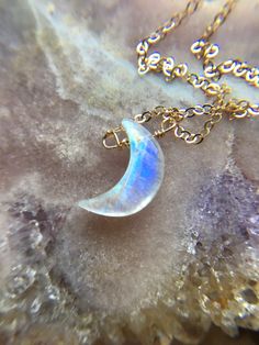 These beautiful dainty necklaces feature high quality Crescent moon rainbow moonstone pendents that I have wire wrapped and placed on a coordinating chain. You can choose the length from the drop down menu. These necklaces provide that Goddess energy that you are looking for helping you to connect to the magic of the moon. 🌚 Intensifies Goddess Energy🌚 Enhances feelings and encourages desires 🌚 Recognize and embrace personal power 🌚 These crystals reflect within them the magical healing qual Moon Stone Necklace Crystals, Crystal Moon Necklace, Moon Crystal Necklace, Unique Moon-shaped Moonstone Necklace, Silver Moon-shaped Magical Necklace, Mystical Silver Moon-shaped Crystal Necklace, Moon Rainbow, Dainty Necklaces, Velvet Jewelry