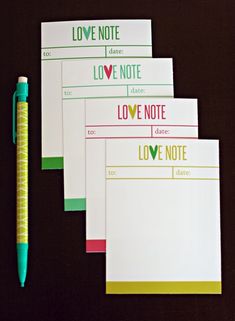 four love note cards and a pen on a black surface with the words love note written in bold colors