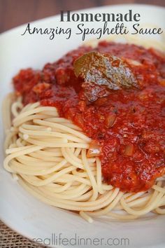 a white plate topped with spaghetti and sauce