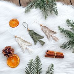 christmas decorations made out of dried orange slices and cinnamon sticks on a white fur background