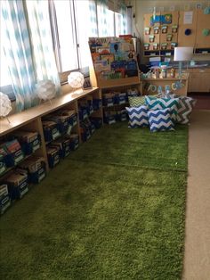 a room filled with lots of green carpet and boxes on the floor next to windows