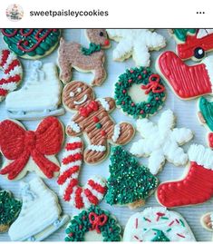 decorated christmas cookies are displayed on a table