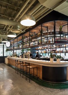 an empty bar with lots of bottles on the shelves