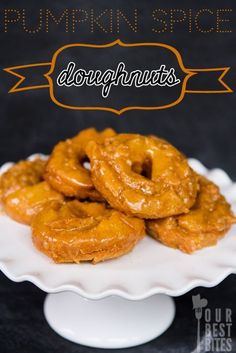 there are some fried doughnuts on a white platter with the words pumpkin spice below it