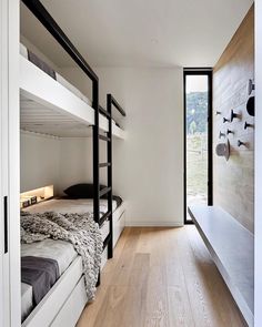 a room with bunk beds and wooden floors