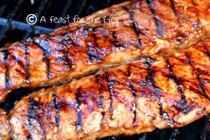 two steaks are cooking on the grill