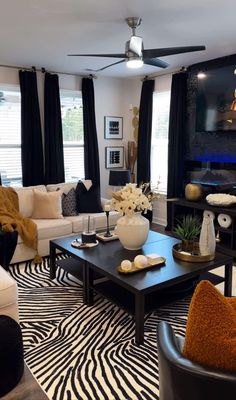 a living room with black and white decor