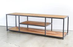 a wooden and metal shelf with two shelves on each side, against a white wall