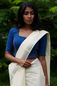 THE KAITHARI PROJECTHand spun & Hand woven in Village Kunnukura, Kerala Indigo hand spun, handwoven richly textured handwoven blouse.Sleeve length : XS - 11", M - 11.5"Model wears an XSDry wash onlyBlouses have plenty of margin along the hand and the bust for alteration if required.SIZING DETAILSHow to MeasureBust: Measure under your arms at fuller part of bust. Keep tape level across shoulder bladeBLOUSESXS : Bust 34-35 inches (86-89 cm)S : Bust 36-37 inches (91-94 cm)M : Bust 38-39 inches Traditional Fitted Blouse With Woven Motifs, Fitted Traditional Blouse With Woven Motifs, Traditional Cotton Saree With Padded Blouse, Fitted Cotton Handloom Blouse Piece, Handloom Fitted Long Sleeve Blouse Piece, Handloom Fitted Long Sleeve Blouse, Fitted Long Sleeve Handloom Blouse Piece, Fitted Long Sleeve Handloom Blouse, Traditional Long Sleeve Handloom Blouse