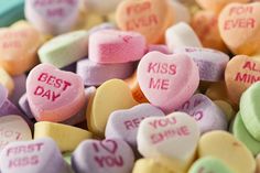 candy hearts with the words kiss me on them