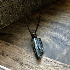 ★Over 500 Sold with lots of 5⭐️ Reviews!Adjustable necklace. Pendants are all unique and are about 1” long. The perfect gift for the stylish man in your life. A jet black piece of raw black tourmaline has been known for centuries as the ultimate protection stone. It is a powerful stone for protection against negative energy of all kinds, as well as being a strong spiritual grounding stone. These natural, raw tourmaline crystals are each unique and hang from soft brown leather cord. Double slip k Stone Necklace For Men, Stone For Protection, Mens Leather Necklace, Black Tourmaline Necklace, Raw Black Tourmaline, Mens Necklace Pendant, Stylish Man, Necklace Mens, Tourmaline Pendant