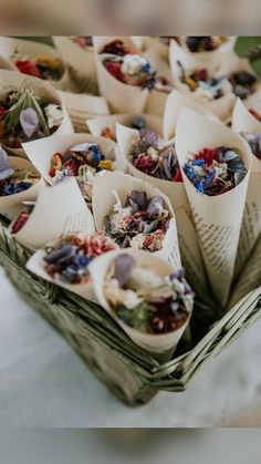 many different types of dried flowers in small baskets