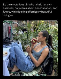 a woman sitting on top of a chair next to an umbrella