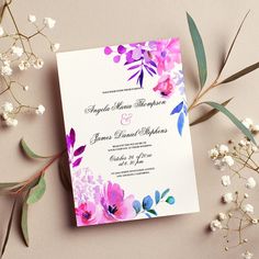 a wedding card with watercolor flowers and greenery