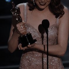 the actress is holding her award for best supporting role in a musical or comedy series