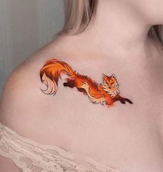 a woman with a tattoo on her chest has a fox design on it's shoulder