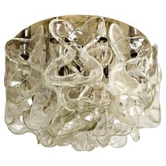 a close up of a light fixture with many glass pieces on the bottom and sides