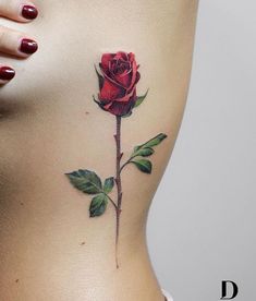 a woman's stomach with a rose tattoo on it