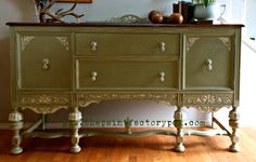 an old dresser is painted green with white trim