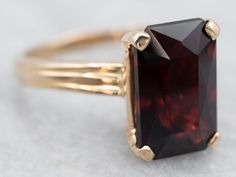 This ring features a simple and classically designed mounting, the structural openwork shoulders lend a sense of light and grace to the mounting. Cut into a classic elongated emerald cut, the deep red cherry garnet in the center adds a lovely pop of color and also an interesting shape to a simple ring!Metal: 14K Yellow GoldGem: Garnet 4.60 CaratsGem Measurements: 7.1 x 11.1 mm, Emerald CutRing Size: 5.25Marks: “14KP 585” Stamped on the inside band Opal Solitaire Ring, Garnet Birthstone, Right Hand Ring, Red Stone Ring, Post Grad, Emerald Cut Rings, Simple Ring, Right Hand Rings, Hand Ring