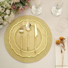 a place setting with silverware and flowers