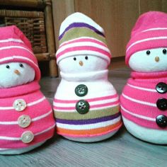 three stuffed snowmen are sitting next to each other