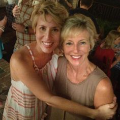 two women are posing for the camera at a party