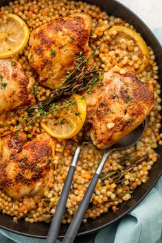 chicken thighs with lemons and lentils in a skillet