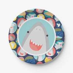 a plate with an image of a shark surrounded by other cartoon animals on it's surface