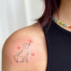 a woman with a dog tattoo on her shoulder