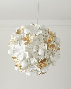 a white and gold flower chandelier hanging from a ceiling