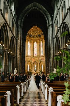 the bride and groom are walking down the aisle in front of the alter at their wedding ceremony