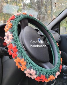 the steering wheel cover is crocheted with flowers