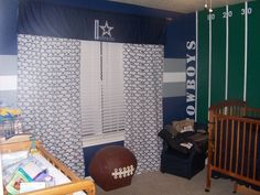 a baby's room decorated in blue, green and white with football themed decor