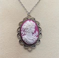 Dark pink and white goddess resin cameo set in alloy plated brass tray. Cameo, not including tray, measures 18x25mm. Please see coin size comparison pics. Chain is 18 inches and made from stainless steel. Brass Tray, Cameo Necklace, Size Comparison, Dark Pink, Pink And White, Necklace Etsy, Jewelry Necklaces, Plating, Necklaces