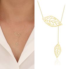 "Introducing the 14K Double Leaves Gold Necklace; A gorgeous and unique piece of jewelry, the Golden Double Leaves Necklace will add elegance to any look. Two golden leaves that softly dangle from a delicate chain are the focal point of this necklace, which was expertly crafted from premium materials. It is the ideal pick for special occasions or to add a touch of sparkle to your everyday outfit because of the wonderful detailing and attractive design. This necklace is sure to become an iconic a Yellow Gold Leaf-shaped Jewelry Gift, Yellow Gold Leaf-shaped Jewelry For Anniversary, Yellow Gold Leaf-shaped Anniversary Jewelry, Anniversary Yellow Gold Leaf Jewelry, Leaf-shaped Yellow Gold Jewelry For Weddings, Leaf-shaped Yellow Gold Wedding Jewelry, Elegant Rose Gold Leaf Jewelry, Gold Lariat Necklace As Fine Jewelry Gift, Dainty Lariat Jewelry For Mother's Day