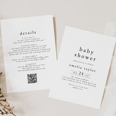 two white cards with black ink on them sitting next to some dried flowers and leaves