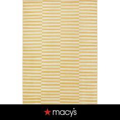 a yellow and white striped rug with stars on the bottom, in front of a black background