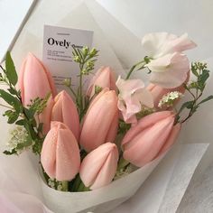 a bouquet of pink tulips and white flowers