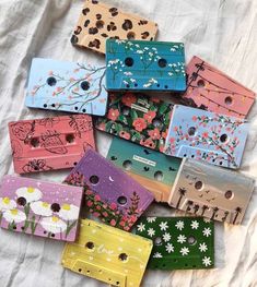 many different colored wooden boxes with flowers on them