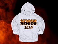 a white hoodie with the words senior on it in yellow and orange letters against a black background